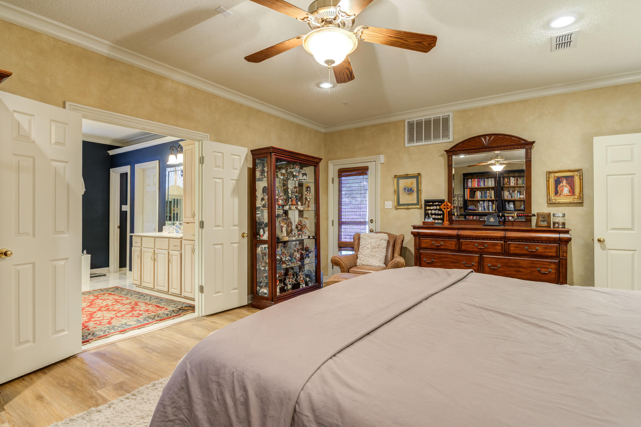 30 West Lakeshore Drive Ransom Canyon, TX 79366 - Photo 32 of 58 a bedroom with a bed and a chandelier