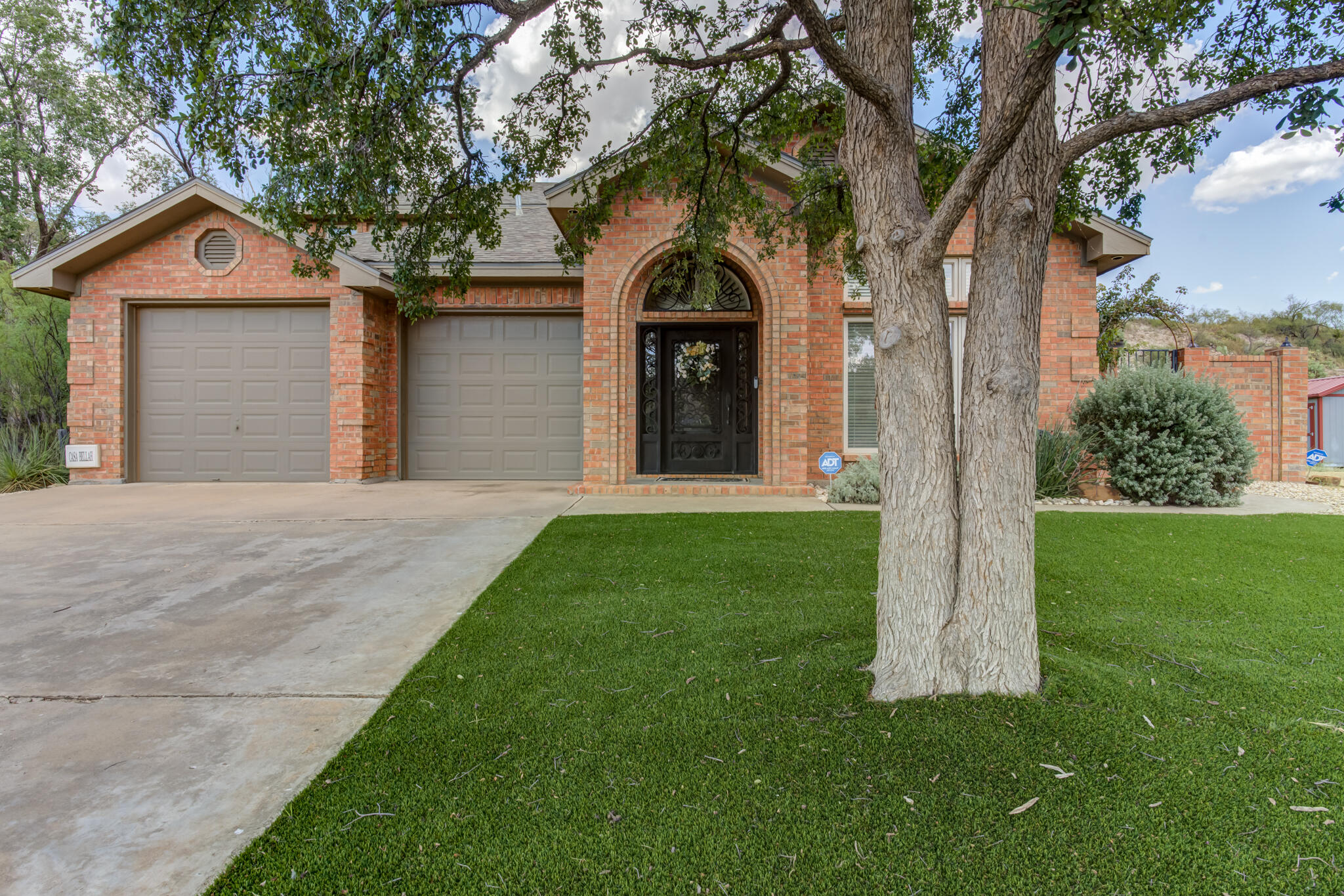 30 West Lakeshore Drive Ransom Canyon, TX 79366 - Photo 4 of 58 a front view of a house with a garden and trees