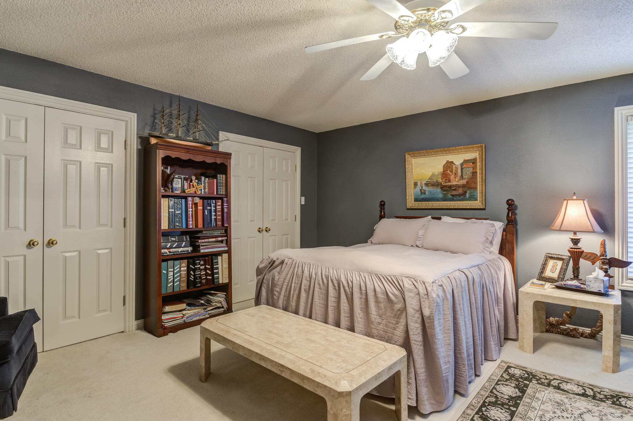 30 West Lakeshore Drive Ransom Canyon, TX 79366 - Photo 46 of 58 a bedroom with a bed and a chandelier
