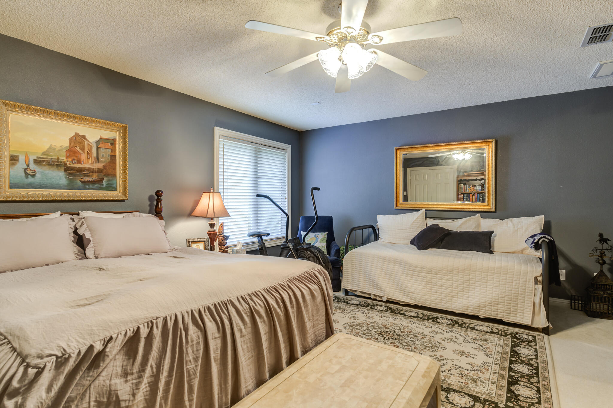 30 West Lakeshore Drive Ransom Canyon, TX 79366 - Photo 47 of 58 a bedroom with two beds and a chandelier