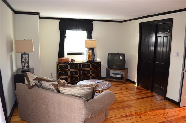 119 Thresher Road Hampden, MA 01036 - Photo 12 of 22 a bedroom with a bed and wooden floor