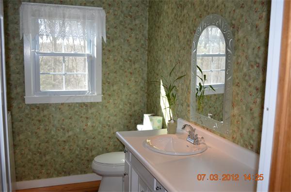 119 Thresher Road Hampden, MA 01036 - Photo 7 of 22 a bathroom with a sink a toilet and a mirror