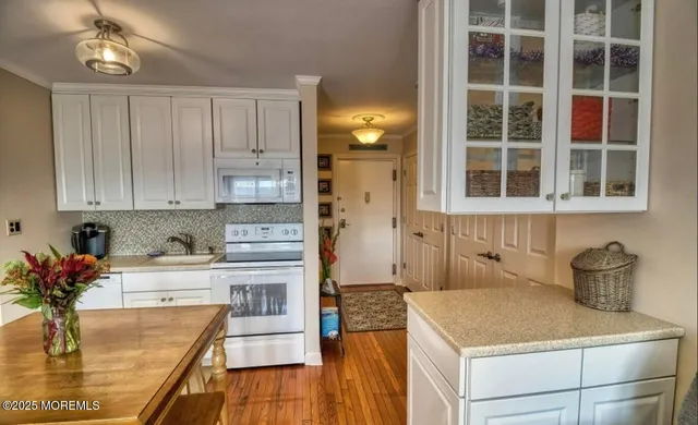 a kitchen with a stove and a white refrigerator