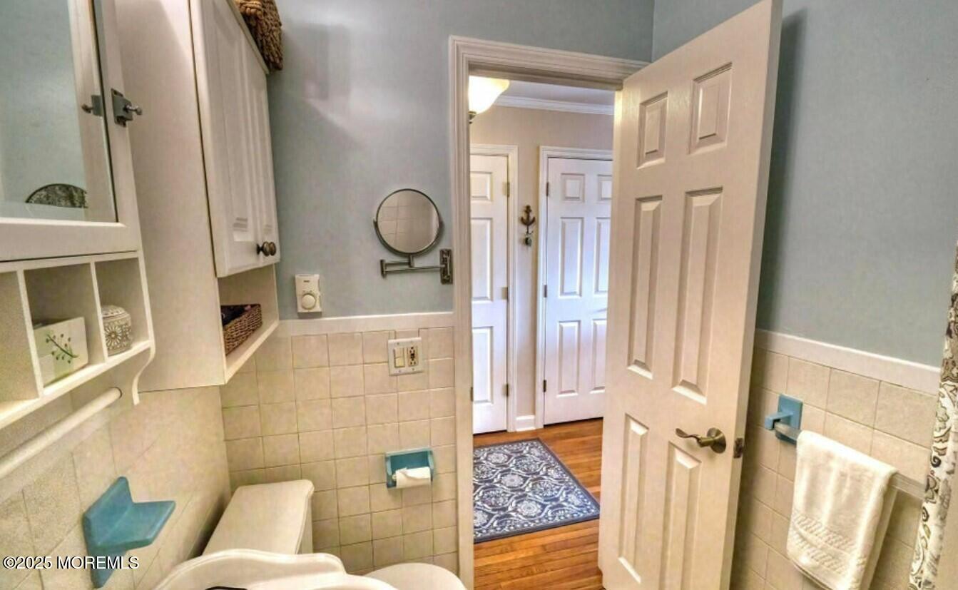 5 Ocean Avenue, Unit 5B Belmar, NJ 07719 - Photo 6 of 13 a bathroom with a sink a toilet and shower