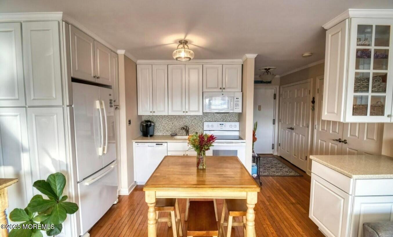 5 Ocean Avenue, Unit 5B Belmar, NJ 07719 - Photo 8 of 13 a kitchen with a refrigerator a stove and a cabinets