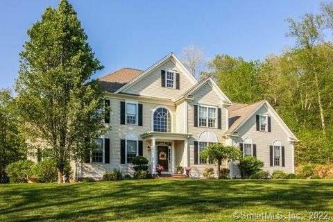 9 Houperts Way Clinton, CT 06413 - Photo 1 of 1 a front view of a house with a garden and plants