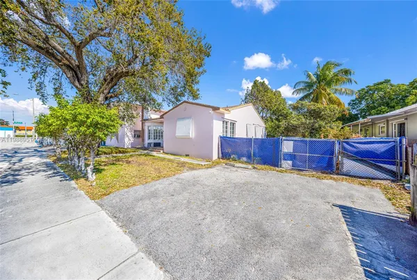 a view of a house with a yard and tree