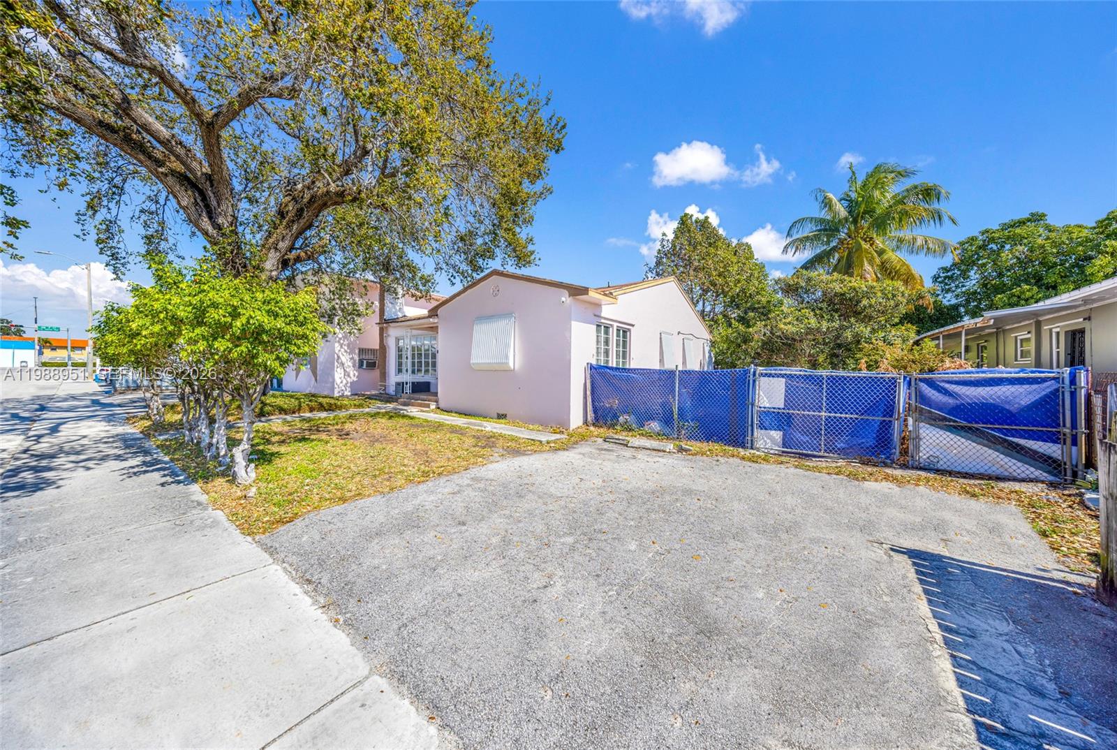605 Northwest 34th Avenue Miami, FL 33125 - Photo 1 of 49 a view of a house with a yard and tree