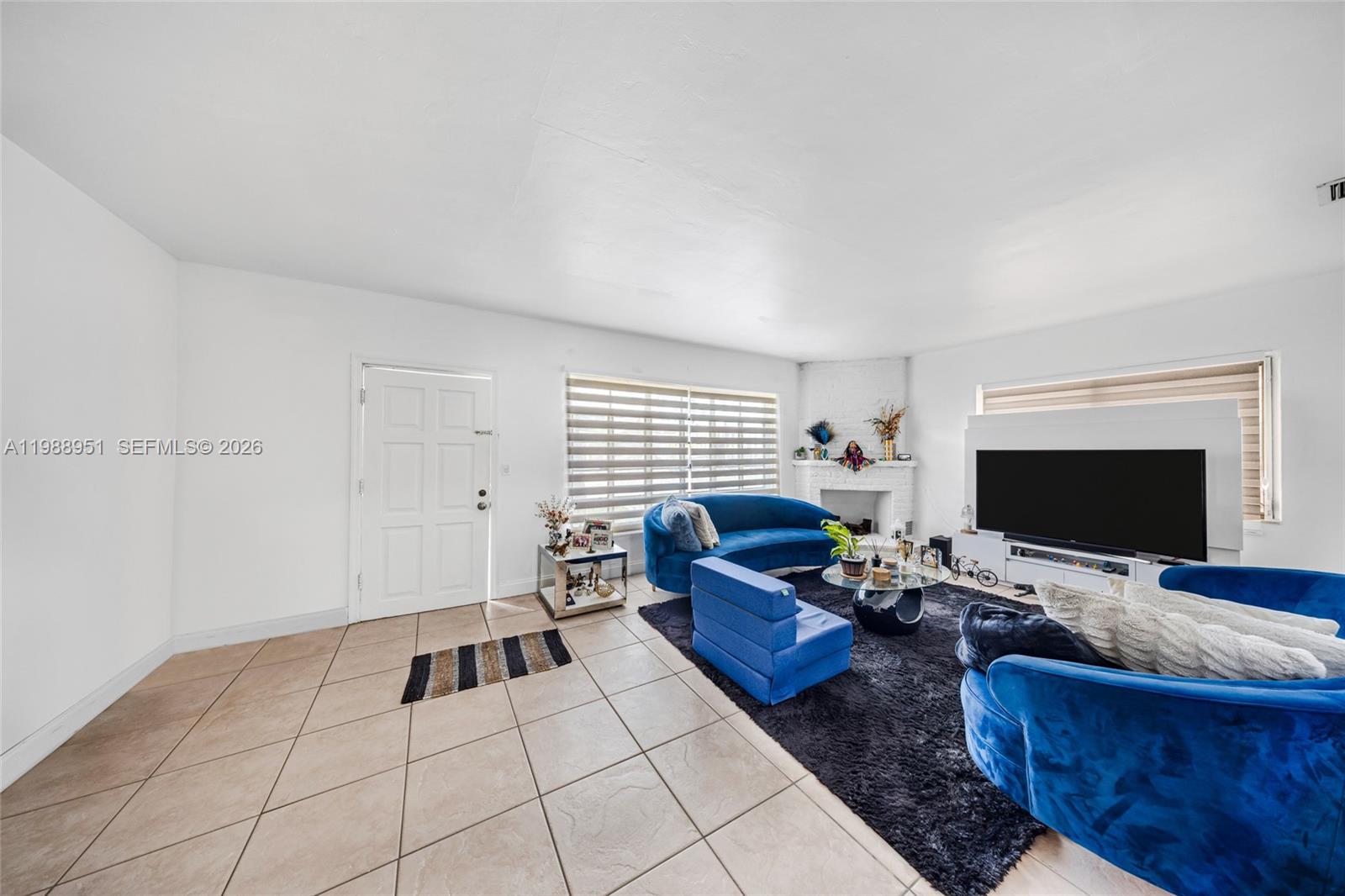 605 Northwest 34th Avenue Miami, FL 33125 - Photo 13 of 49 a living room with furniture and a flat screen tv