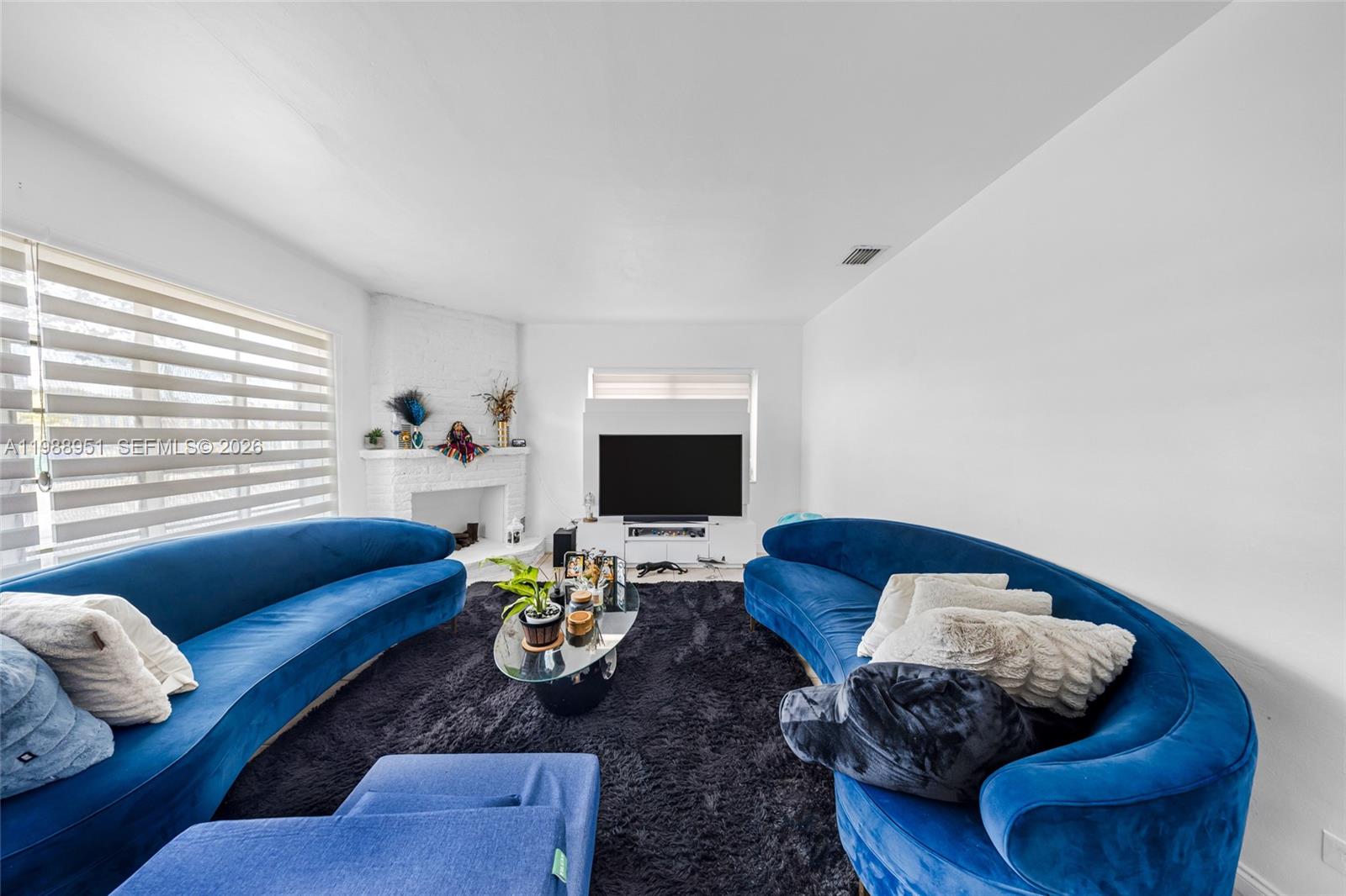 605 Northwest 34th Avenue Miami, FL 33125 - Photo 14 of 49 a living room with furniture and a window