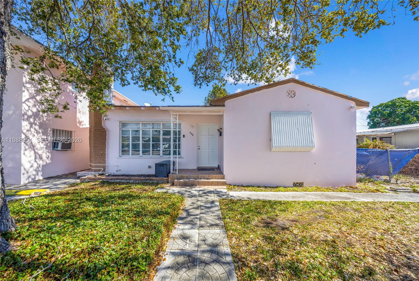 605 Northwest 34th Avenue Miami, FL 33125 - Photo 2 of 49 a front view of house with yard