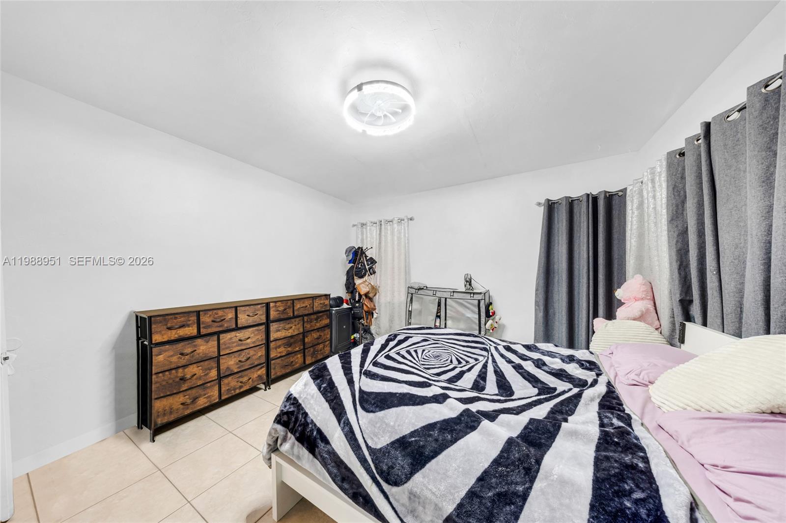 605 Northwest 34th Avenue Miami, FL 33125 - Photo 22 of 49 a bedroom with a bed and a dresser