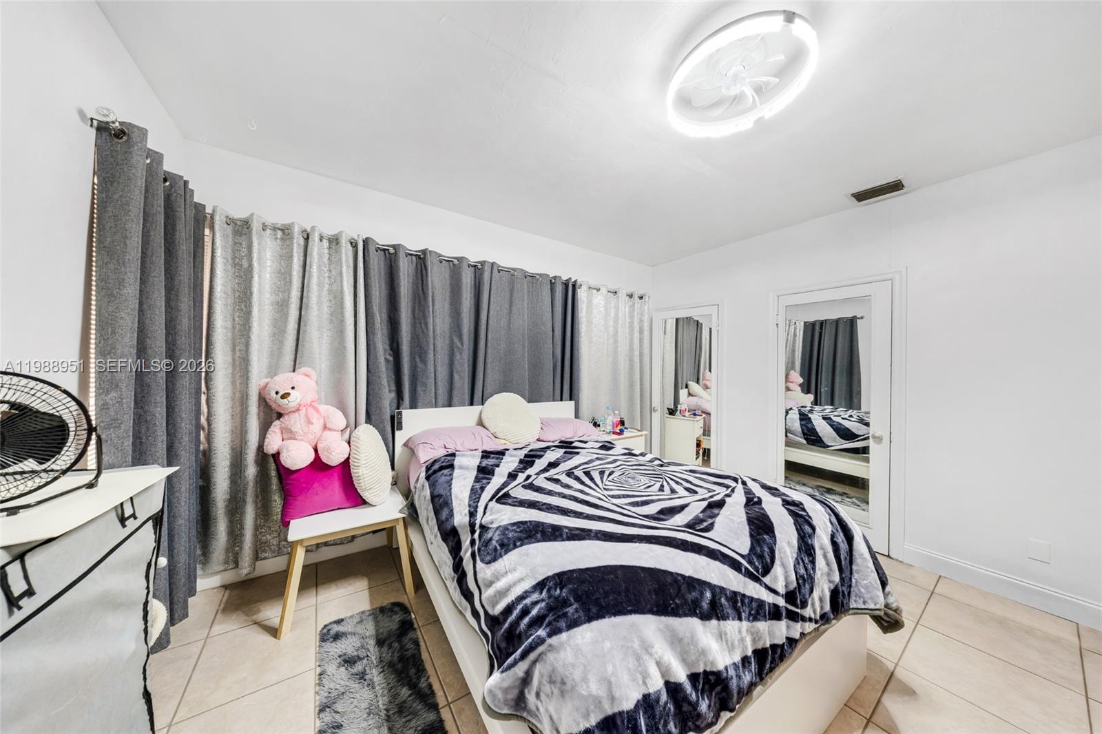 605 Northwest 34th Avenue Miami, FL 33125 - Photo 23 of 49 a bedroom with a bed and a window