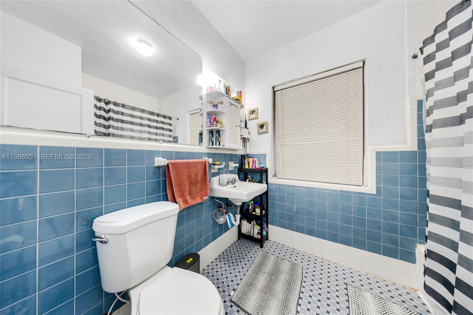 605 Northwest 34th Avenue Miami, FL 33125 - Photo 24 of 49 a bathroom with a toilet a sink and a shower