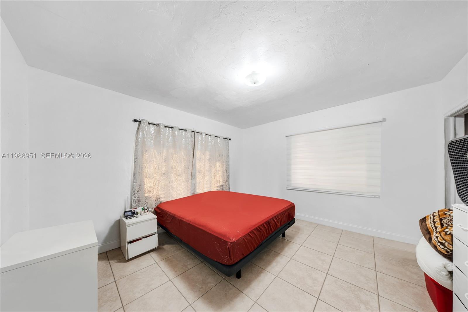 605 Northwest 34th Avenue Miami, FL 33125 - Photo 25 of 49 a bedroom with a bed and a table