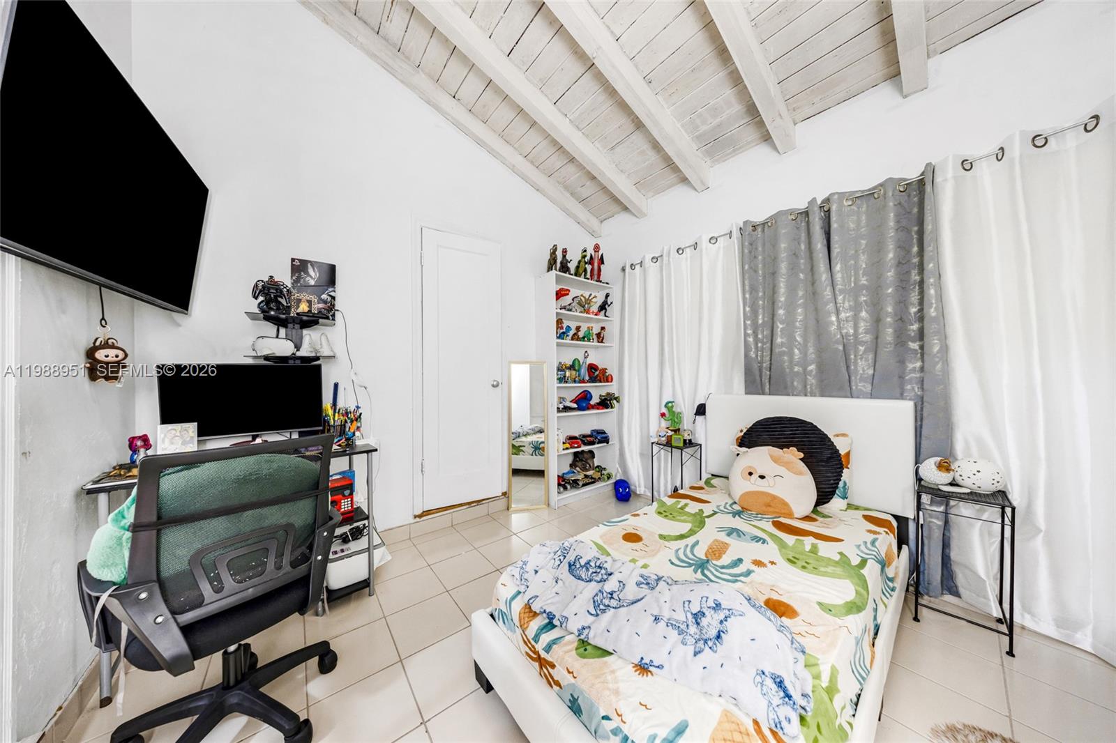 605 Northwest 34th Avenue Miami, FL 33125 - Photo 27 of 49 a bedroom with a bed a flat screen tv and a couch