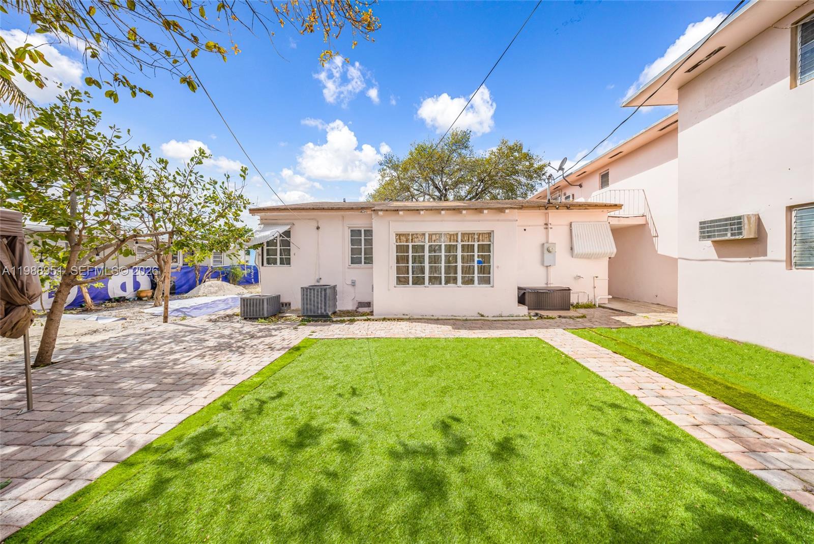 605 Northwest 34th Avenue Miami, FL 33125 - Photo 32 of 49 a view of a house with backyard and a tree