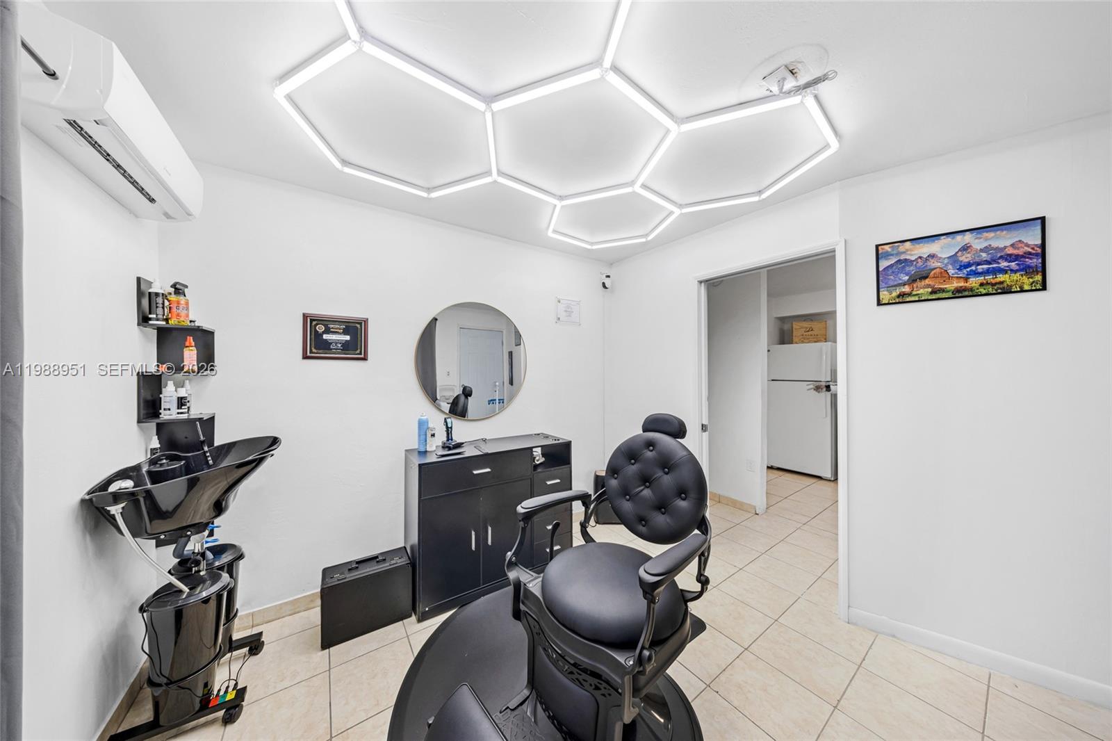 605 Northwest 34th Avenue Miami, FL 33125 - Photo 39 of 49 a workspace with furniture and wooden floor