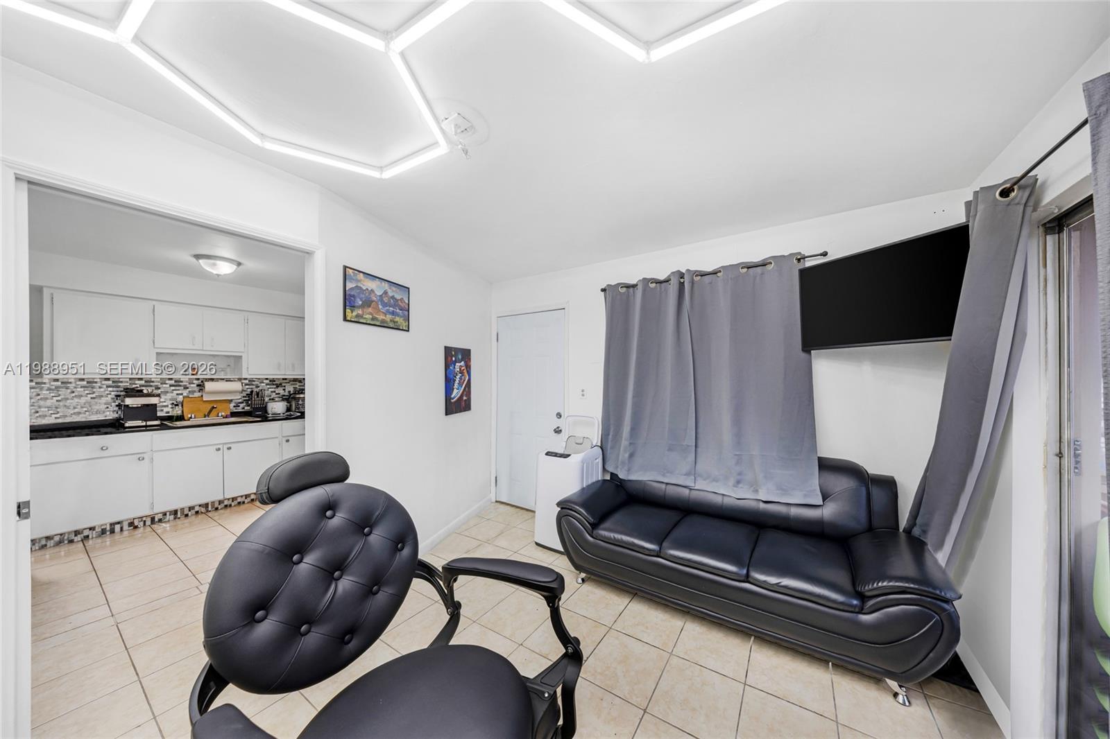 605 Northwest 34th Avenue Miami, FL 33125 - Photo 40 of 49 a living room with furniture and a flat screen tv