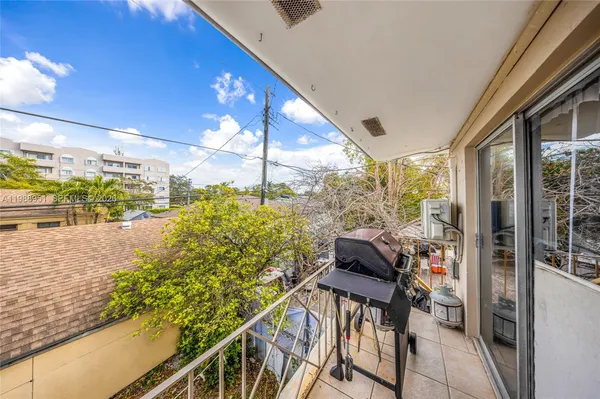 a view of a balcony with an outdoor seating