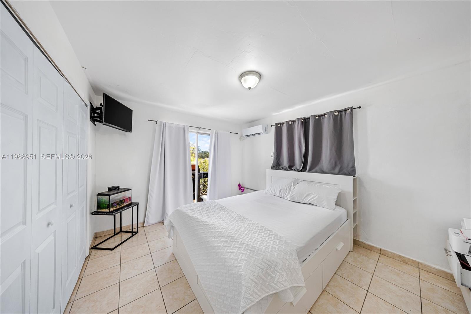 605 Northwest 34th Avenue Miami, FL 33125 - Photo 46 of 49 a bedroom with a bed and a view of bathroom