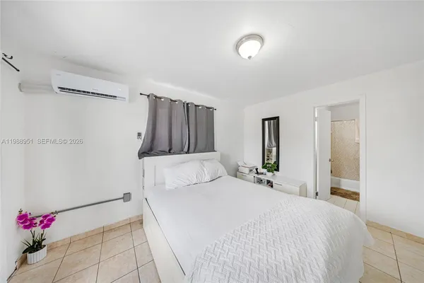 a bedroom with a bed and a flat screen tv