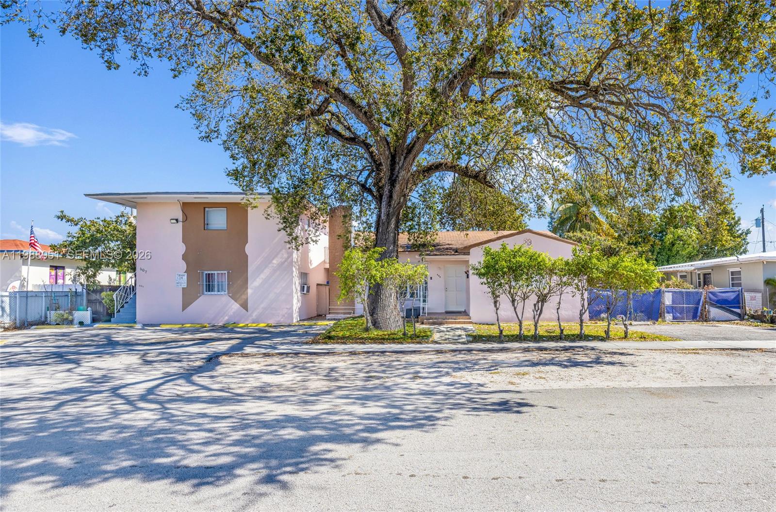 605 Northwest 34th Avenue Miami, FL 33125 - Photo 5 of 49 a house with trees in front of it