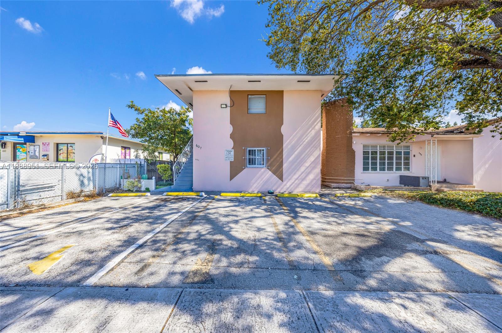 605 Northwest 34th Avenue Miami, FL 33125 - Photo 7 of 49 a view of a house with a yard and tree