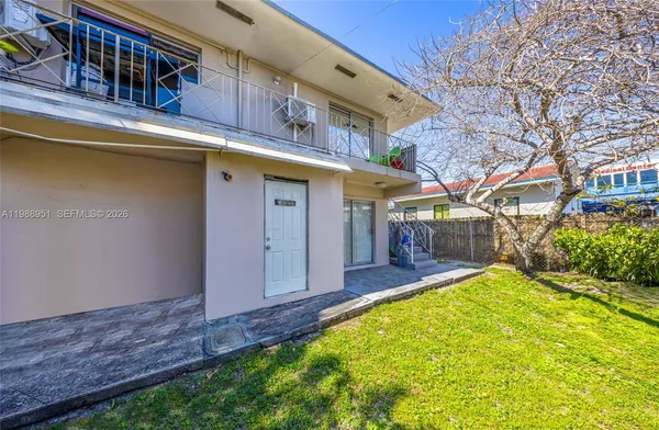 a view of a house with a yard patio and fire pit