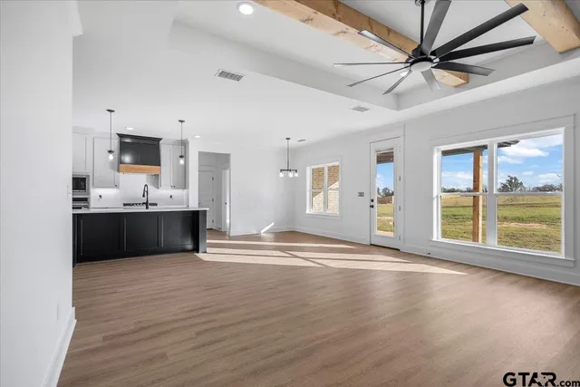 a view of a kitchen with a sink and a refrigerator
