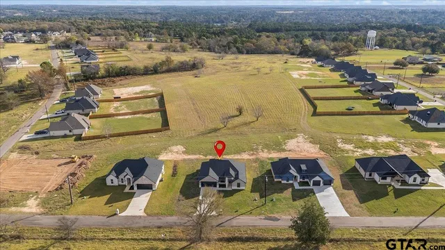 an aerial view of a house with a swimming pool