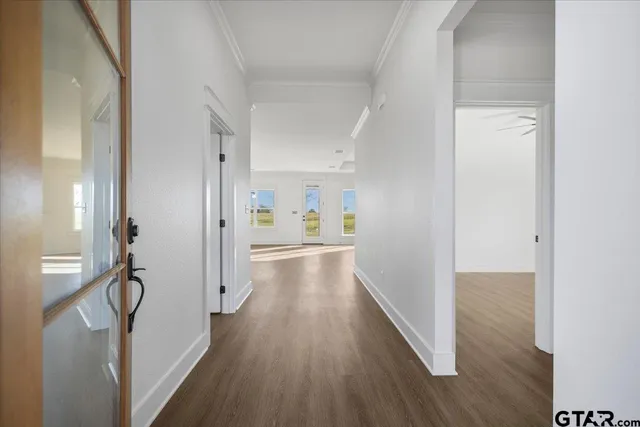 a kitchen with stainless steel appliances granite countertop a refrigerator a stove and a wooden floors