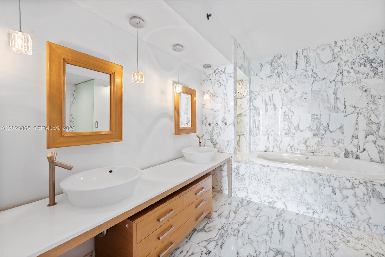 450 Alton Road, Unit 3206 Miami Beach, FL 33139 - Photo 13 of 25 a bathroom with a double vanity sink mirror and shower
