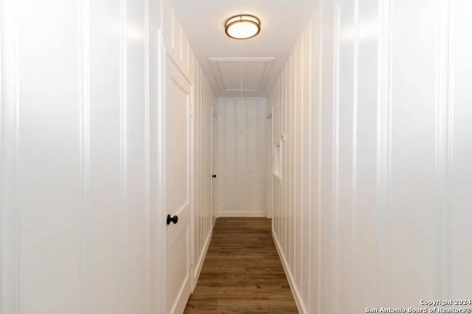 719 Kelly Street Poteet, TX 78065 - Photo 8 of 12 a view of a hallway with wooden floor
