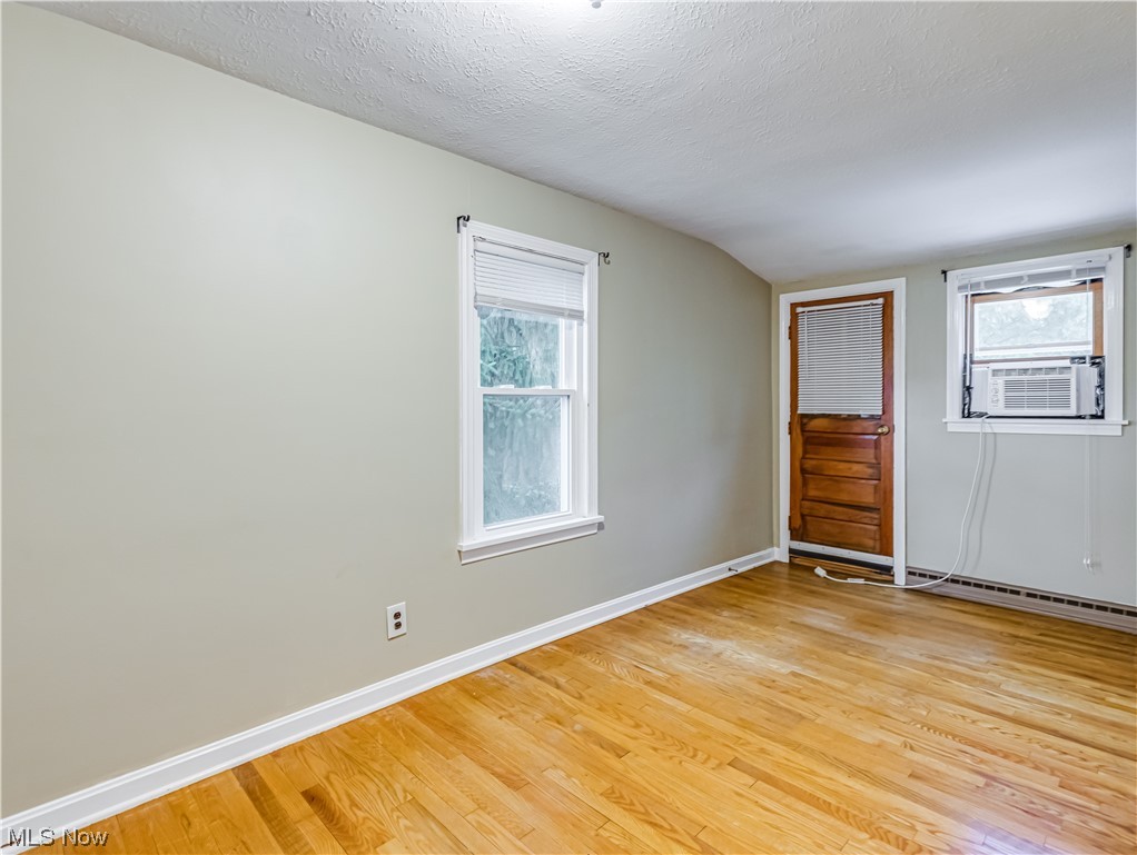 4349 Broadview Road Richfield, OH 44286 - Photo 18 of 20 Wood floored empty room featuring a textured ceiling and vaulted ceiling