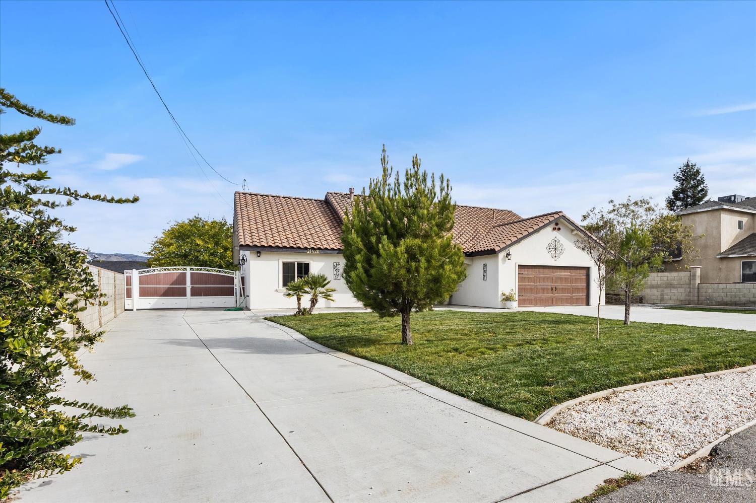 Undisclosed Address Tehachapi, CA 93561 - Photo 12 of 62 a front view of a house with a yard and garage