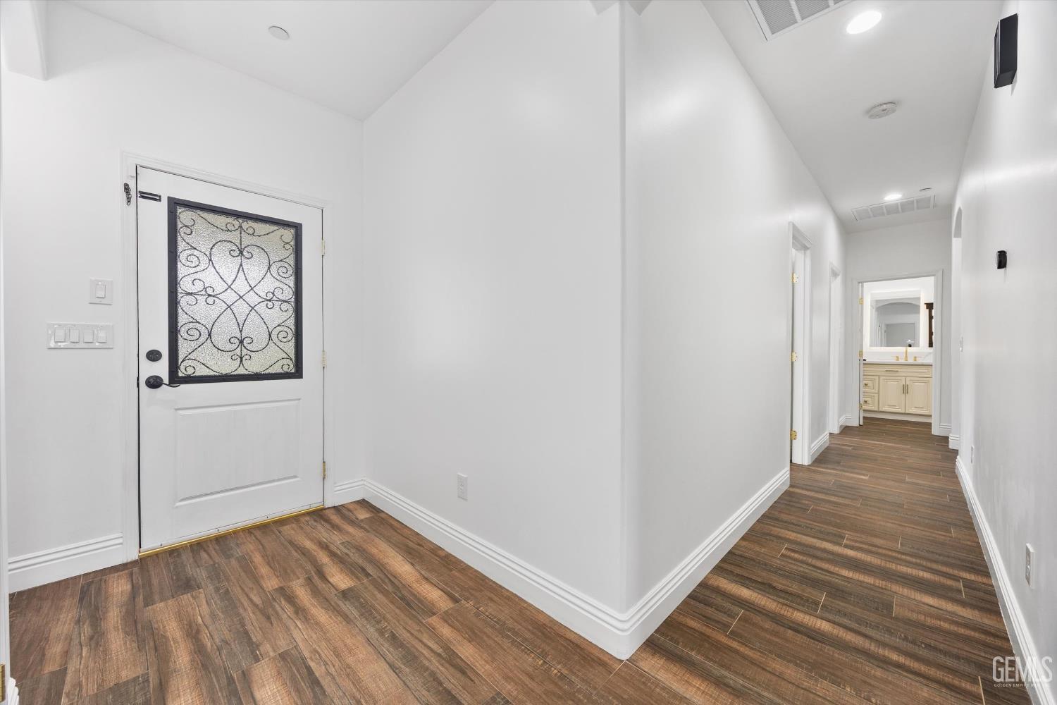 Undisclosed Address Tehachapi, CA 93561 - Photo 17 of 62 a view of a hallway with wooden floor