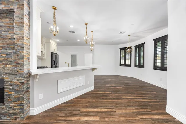 a kitchen with cabinets appliances a sink and a counter top space