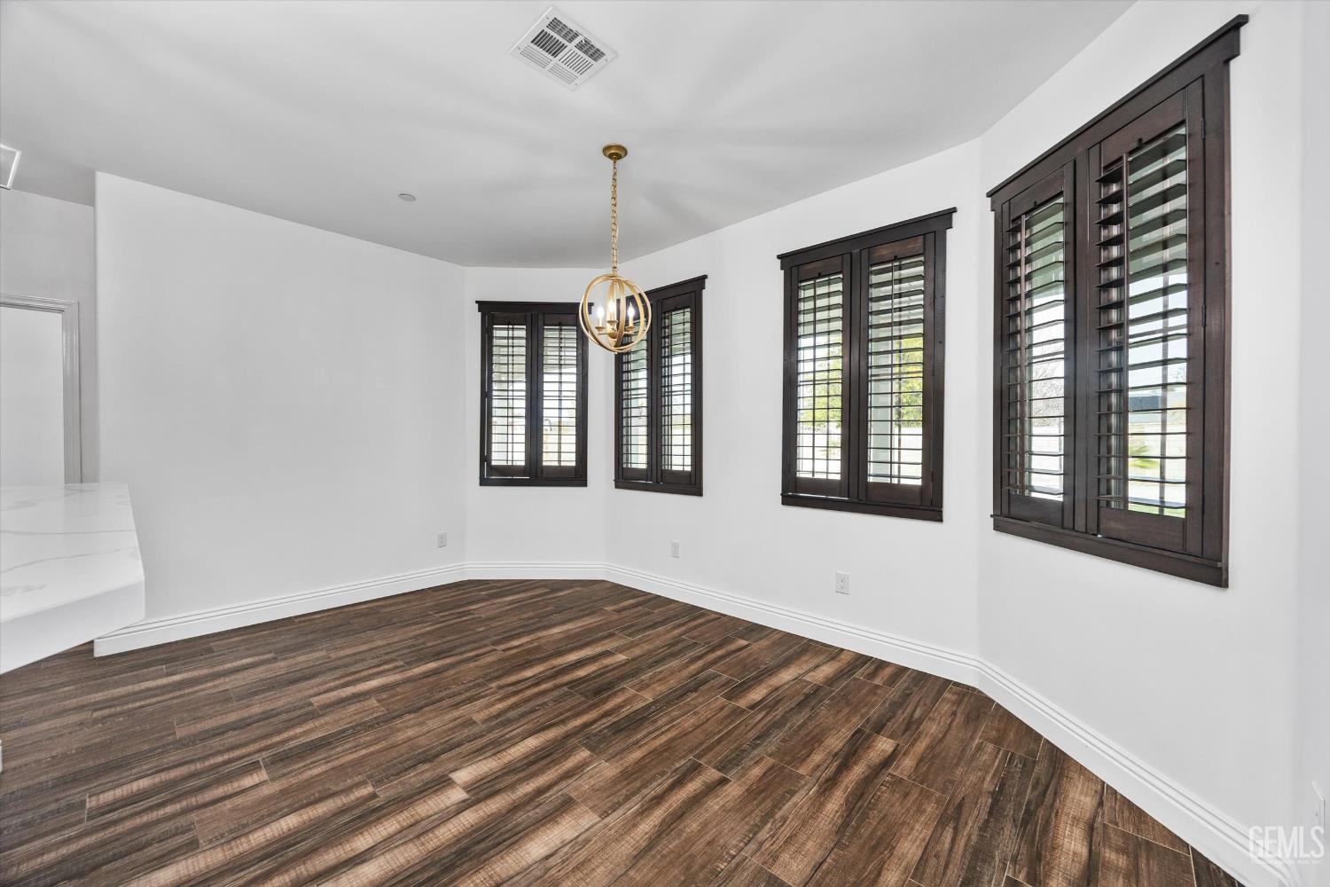 Undisclosed Address Tehachapi, CA 93561 - Photo 25 of 62 a view of an empty room with wooden floor and a window