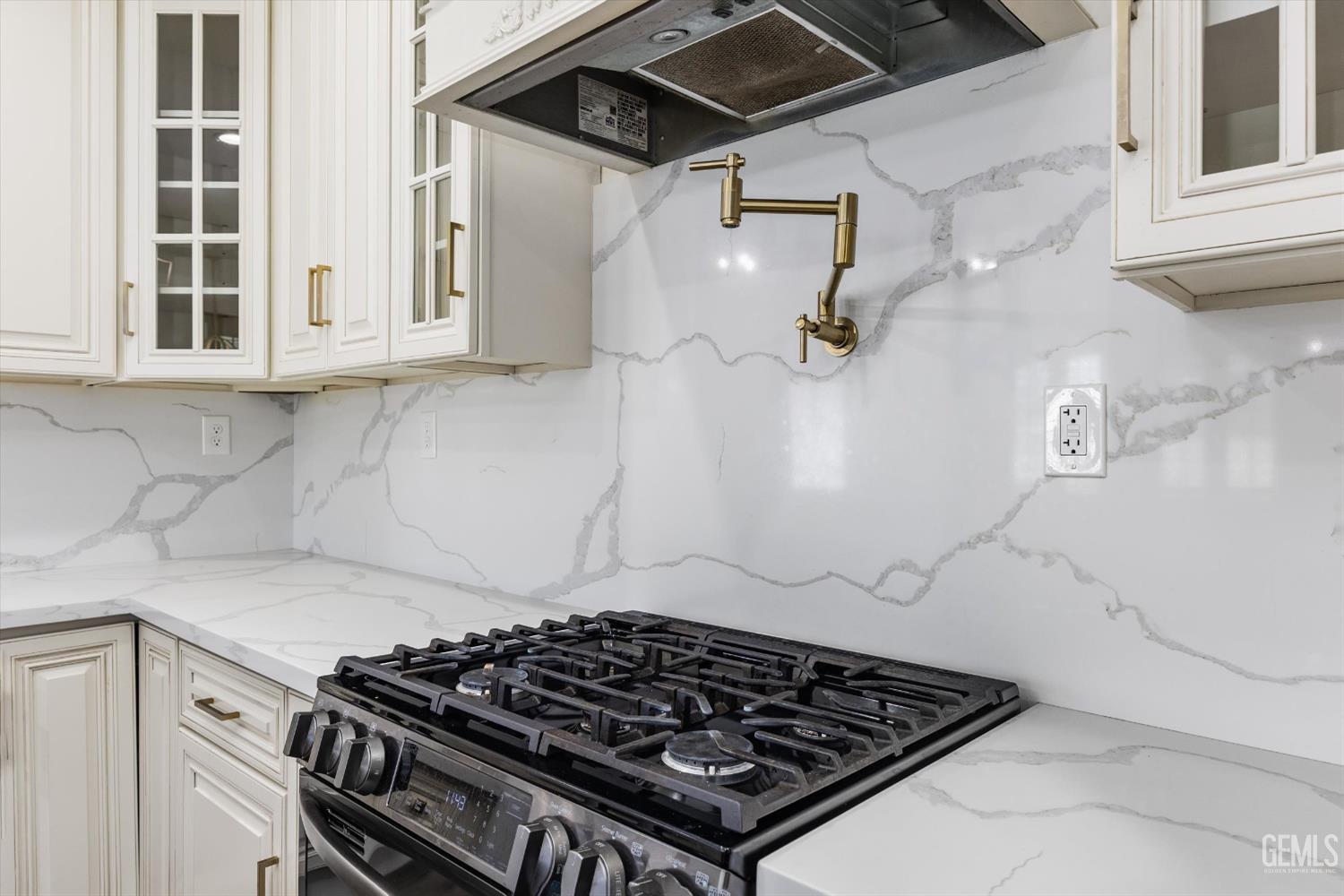Undisclosed Address Tehachapi, CA 93561 - Photo 31 of 62 a stove sitting inside of a kitchen with white cabinets