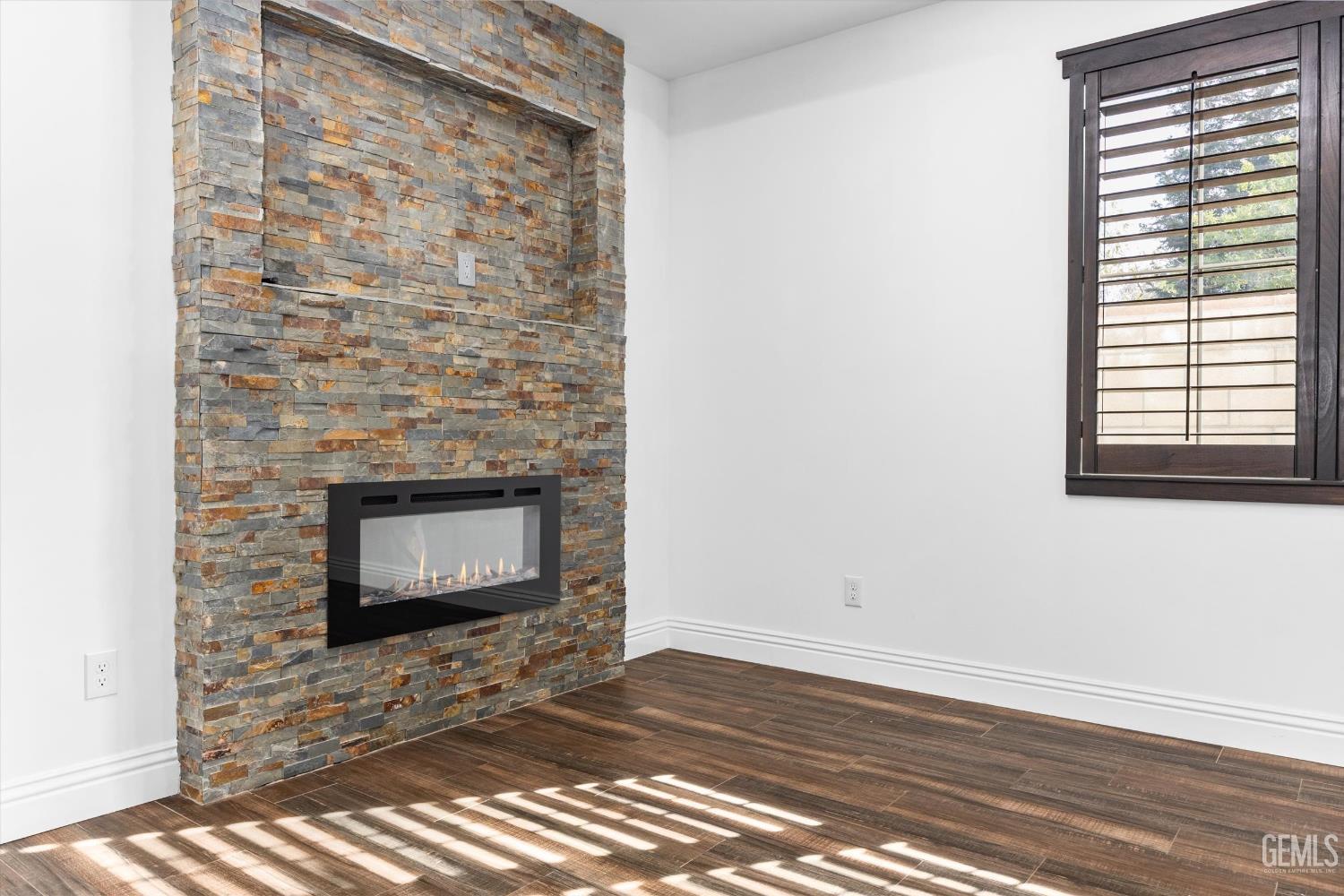 Undisclosed Address Tehachapi, CA 93561 - Photo 35 of 62 a view of an empty room with wooden floor and a fireplace