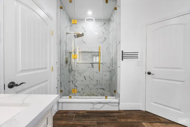 a view of an empty room with wooden floor