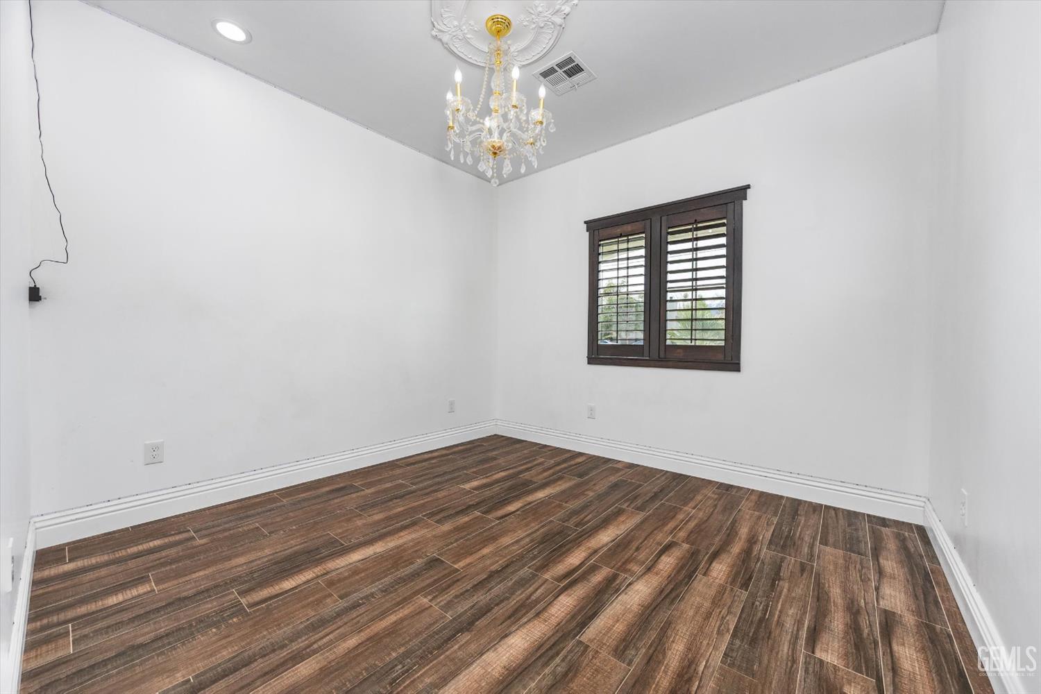 Undisclosed Address Tehachapi, CA 93561 - Photo 41 of 62 a view of an empty room with wooden floor and a window