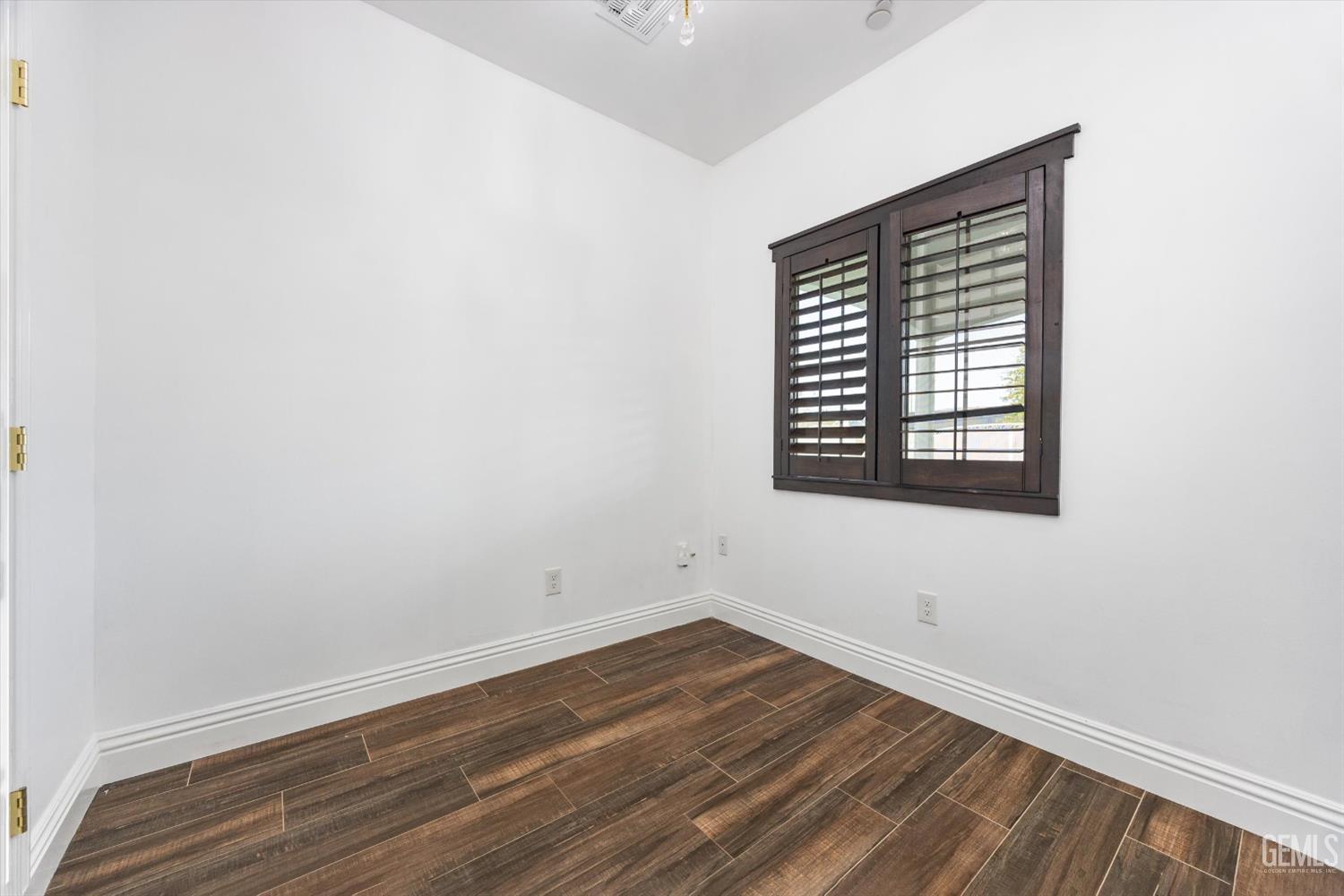 Undisclosed Address Tehachapi, CA 93561 - Photo 50 of 62 a view of an empty room with wooden floor and a window