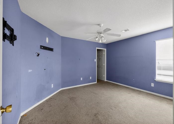 4922 Redwing Brook Trail Katy, TX 77449 - Photo 11 of 22 an empty room with windows and fan