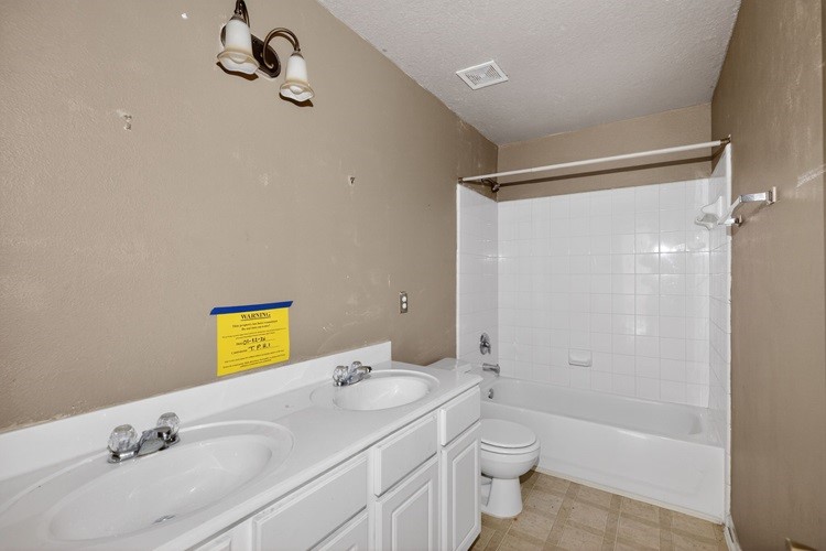 4922 Redwing Brook Trail Katy, TX 77449 - Photo 21 of 22 a bathroom with a granite countertop sink toilet and shower