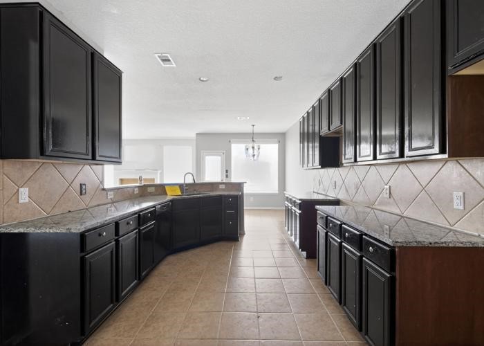 4922 Redwing Brook Trail Katy, TX 77449 - Photo 8 of 22 a kitchen with stainless steel appliances granite countertop a sink and stove