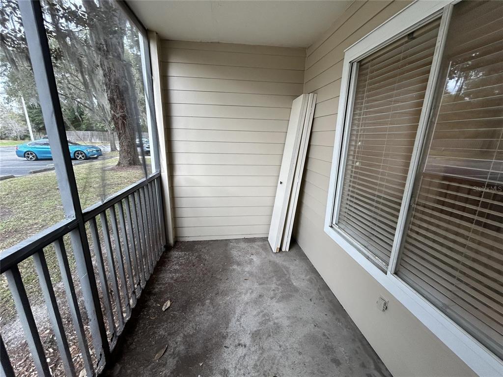 3800 Southwest 20th Avenue, Unit 403 Gainesville, FL 32607 - Photo 5 of 8 a view of a balcony with wooden floor and fence