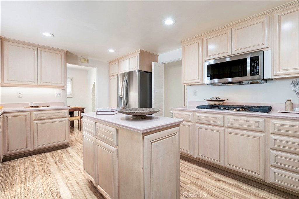 143 Roycroft Avenue Long Beach, CA 90803 - Photo 18 of 45 a kitchen with stainless steel appliances a stove sink microwave and cabinets