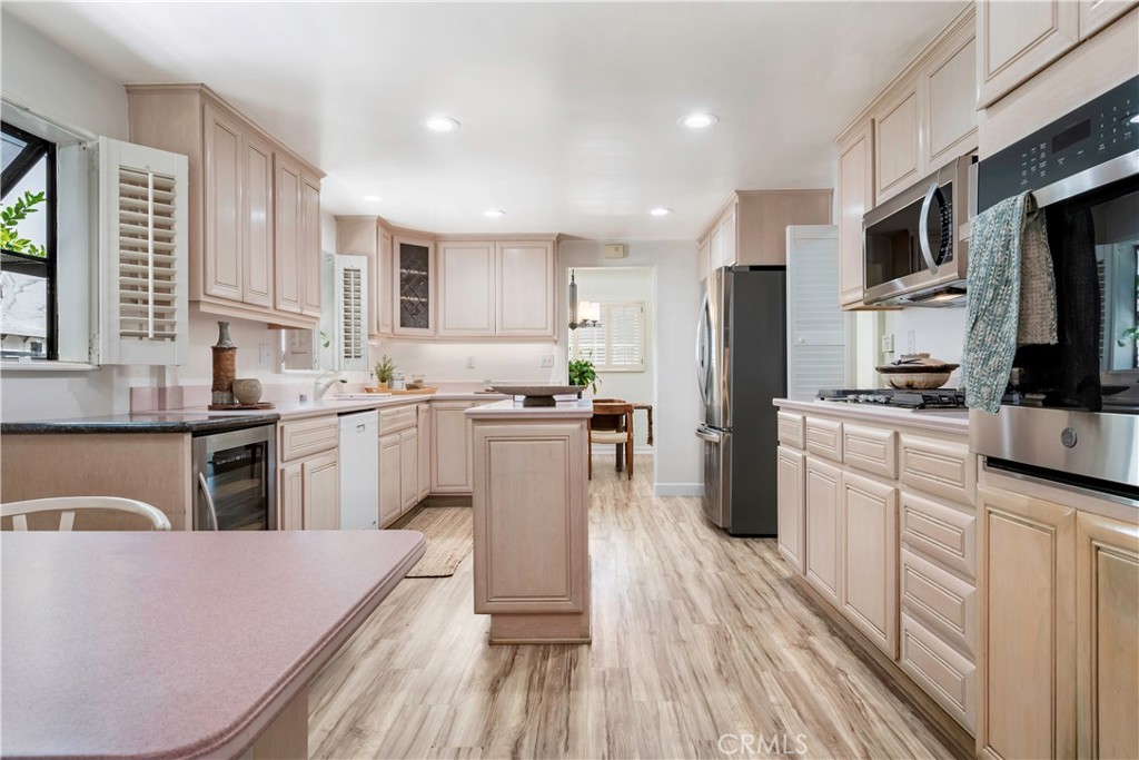 143 Roycroft Avenue Long Beach, CA 90803 - Photo 19 of 45 a kitchen with granite countertop a sink cabinets stainless steel appliances and a window